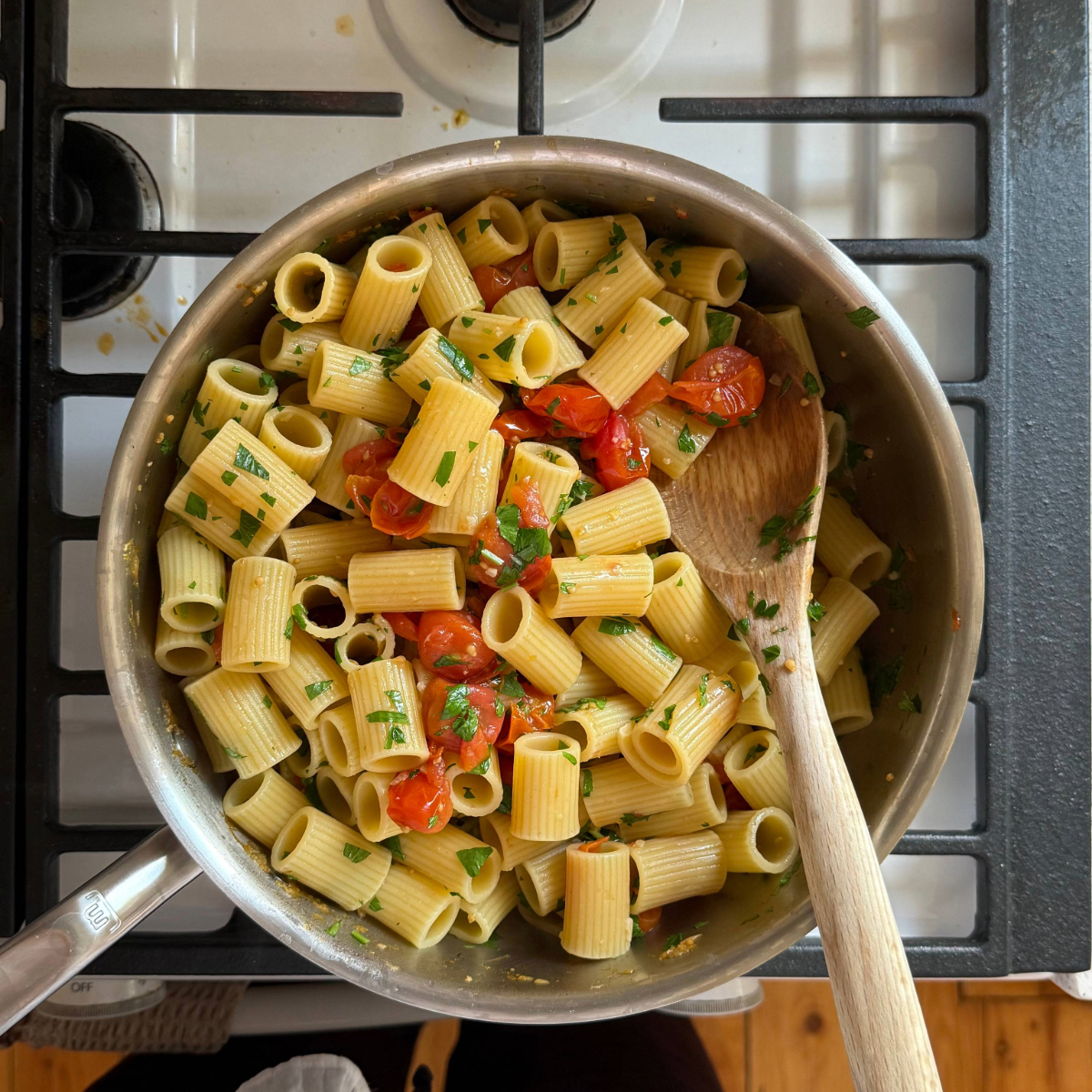 pasta in a sauce pan with cherry tomatoes