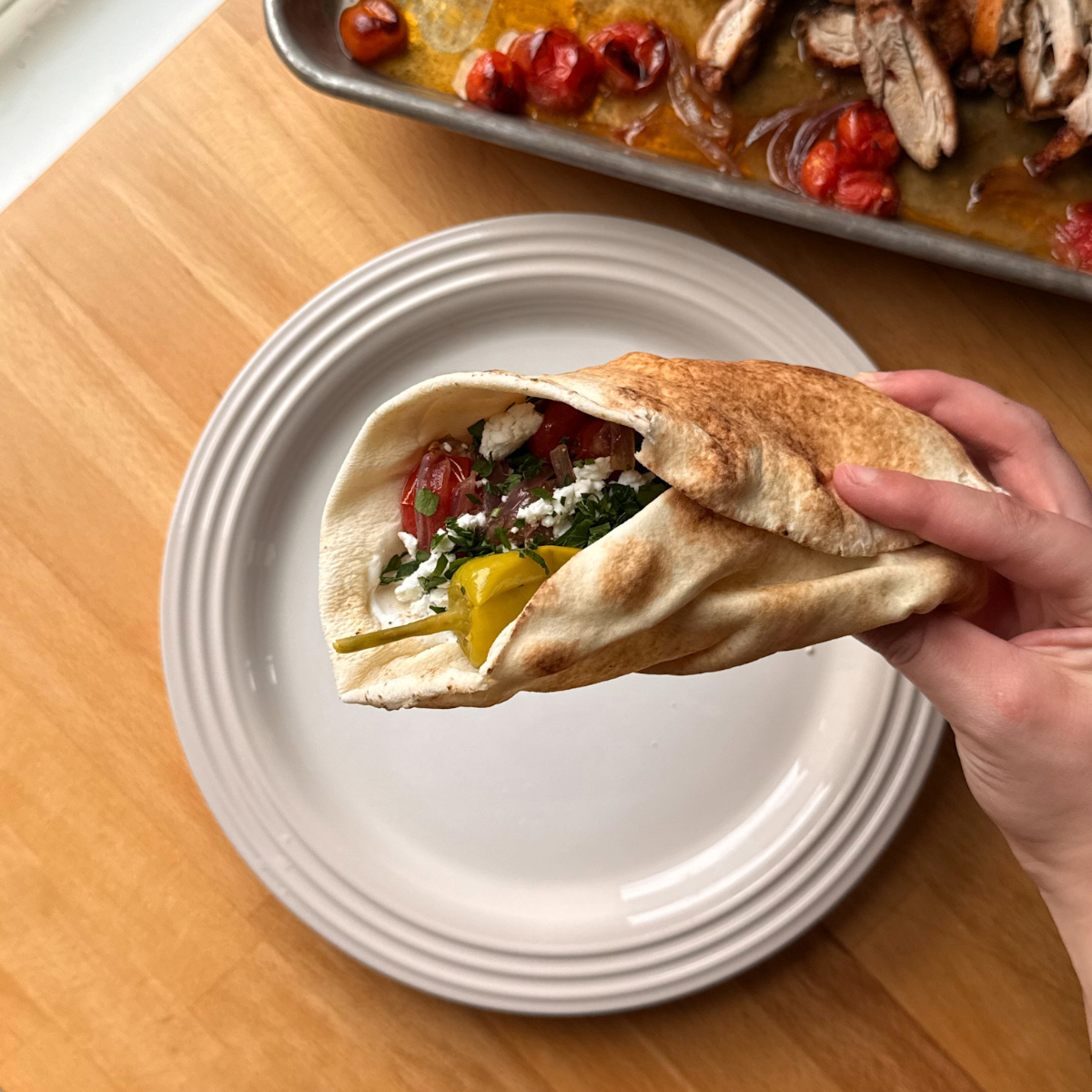 Sheet pan chicken shawarma wrapped in a pita